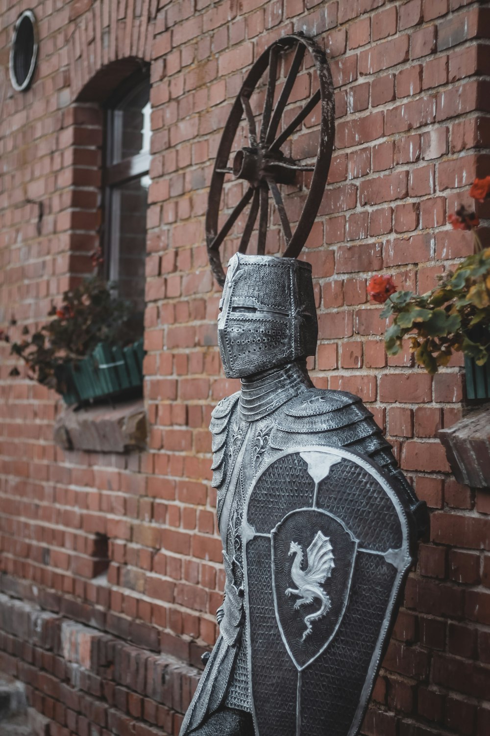 a statue of a knight in front of a brick building