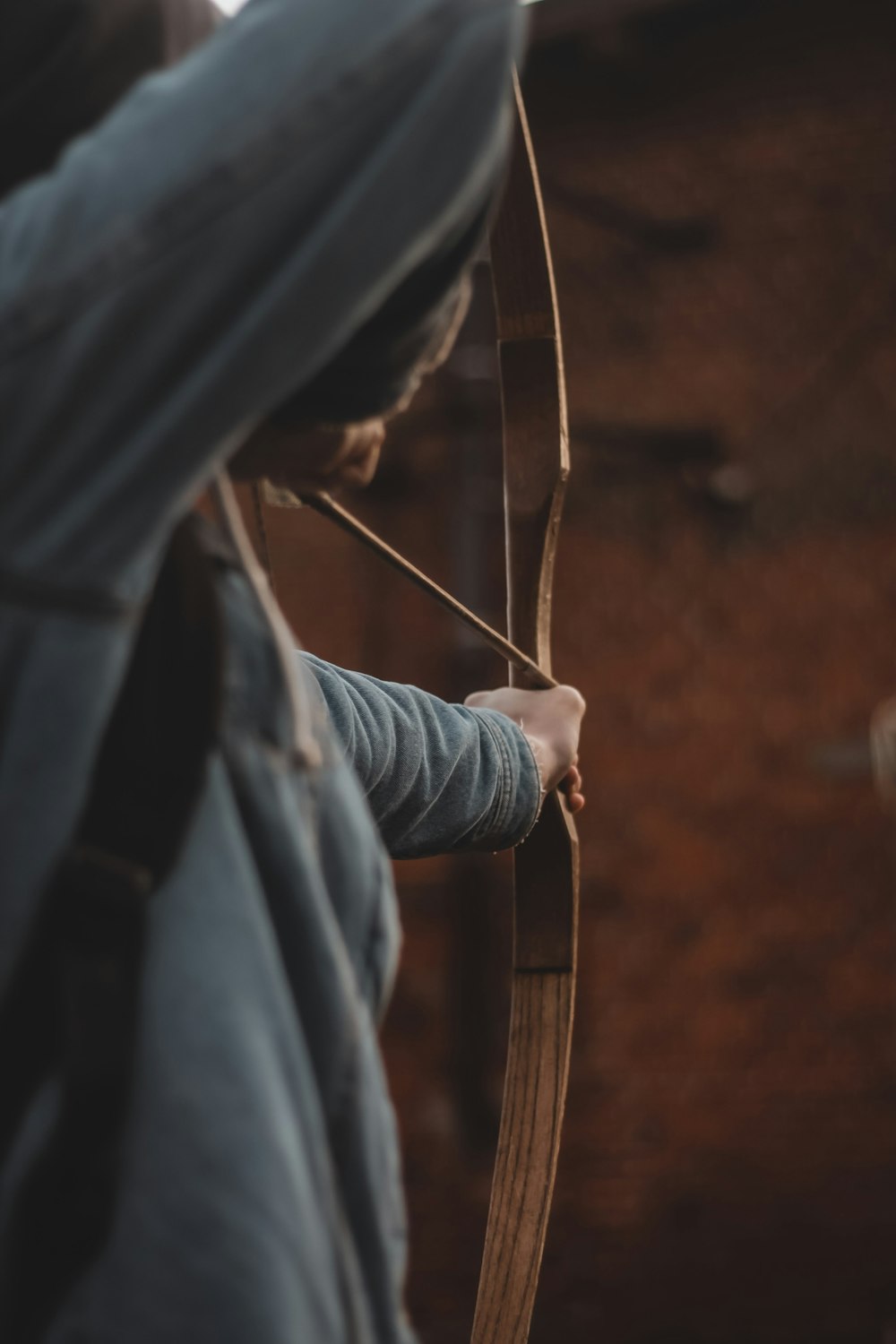 a person holding a bow and aiming it at something