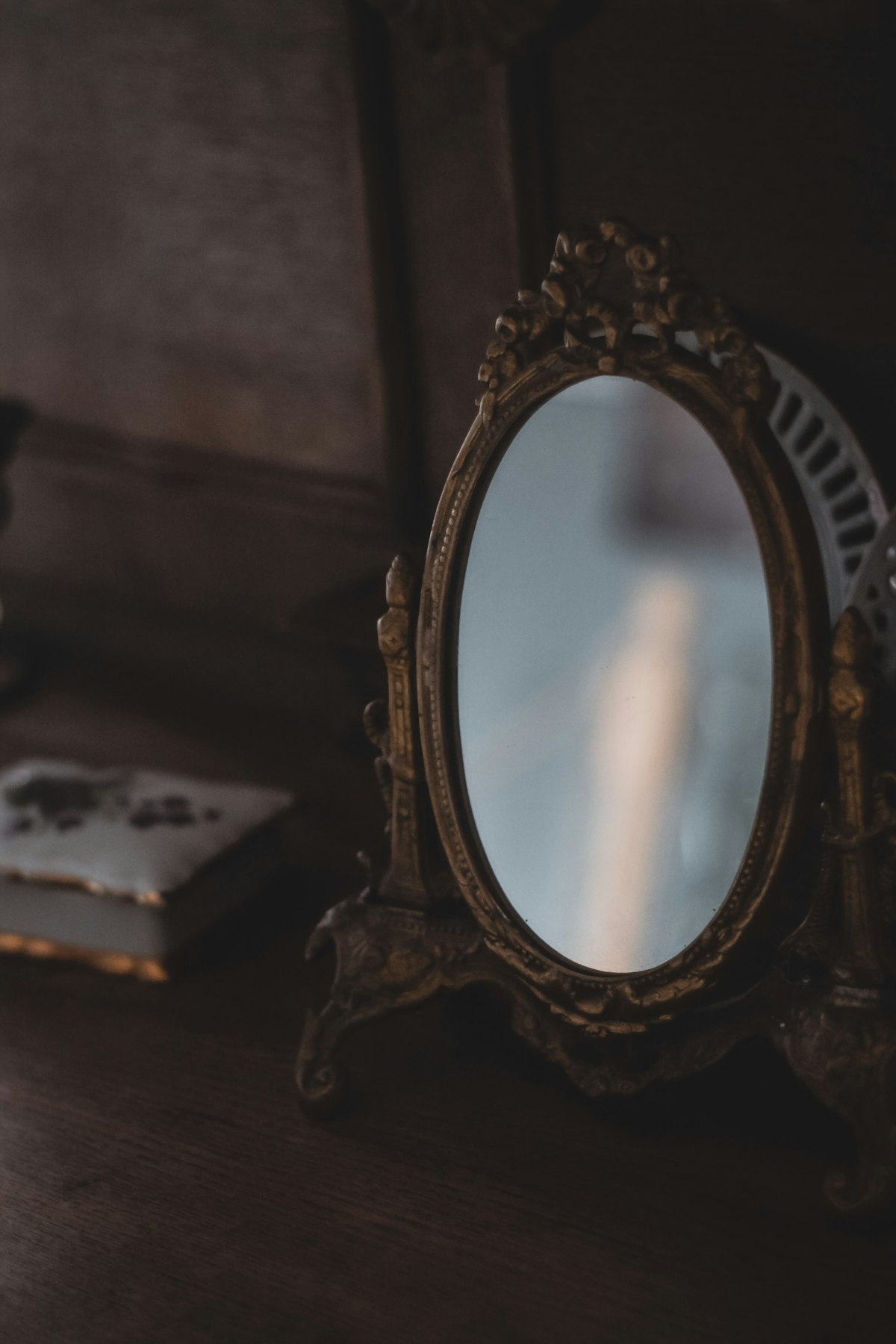 Mirror sitting on top of a wooden dresser