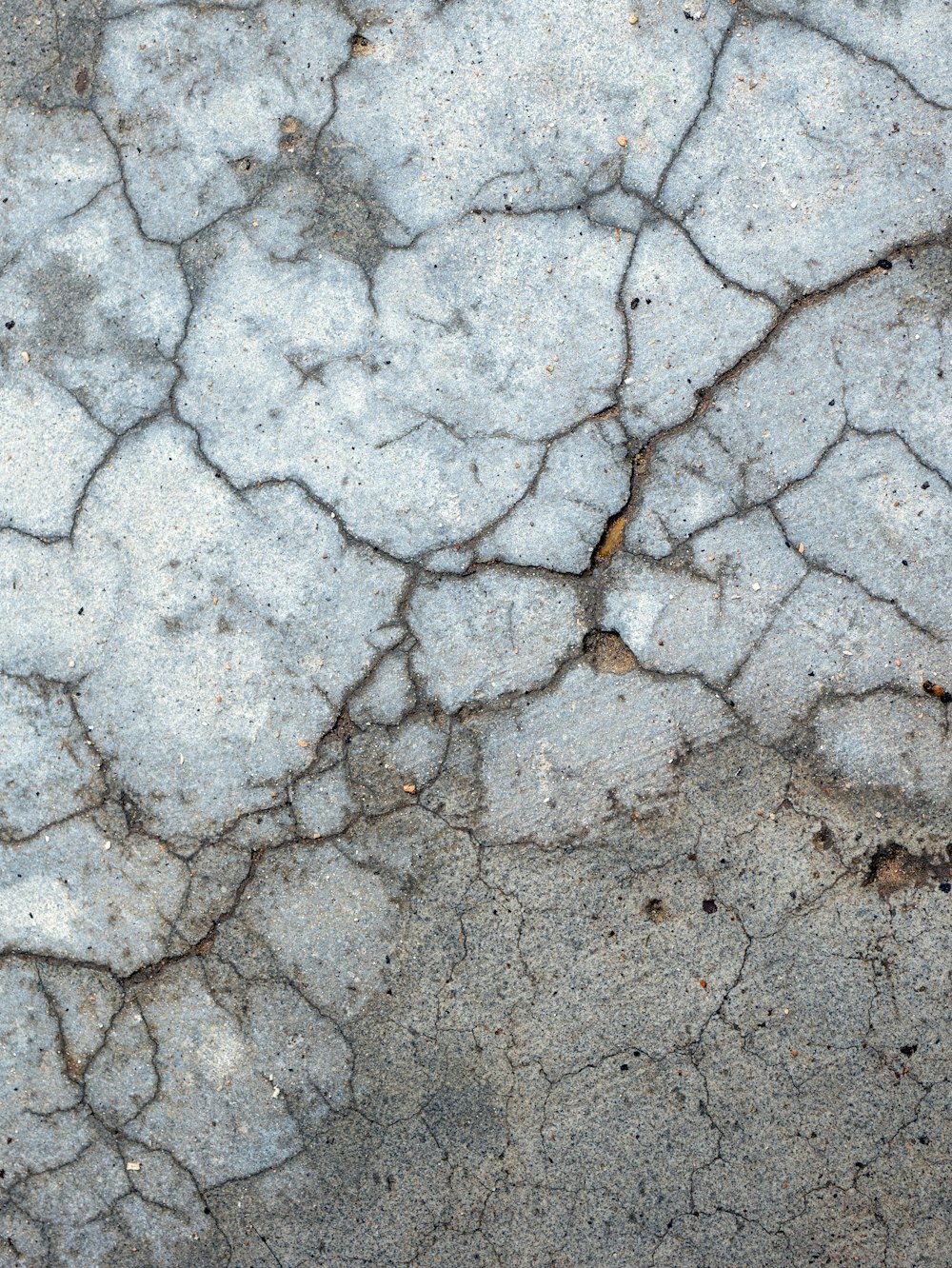 a close up of a cracked concrete surface