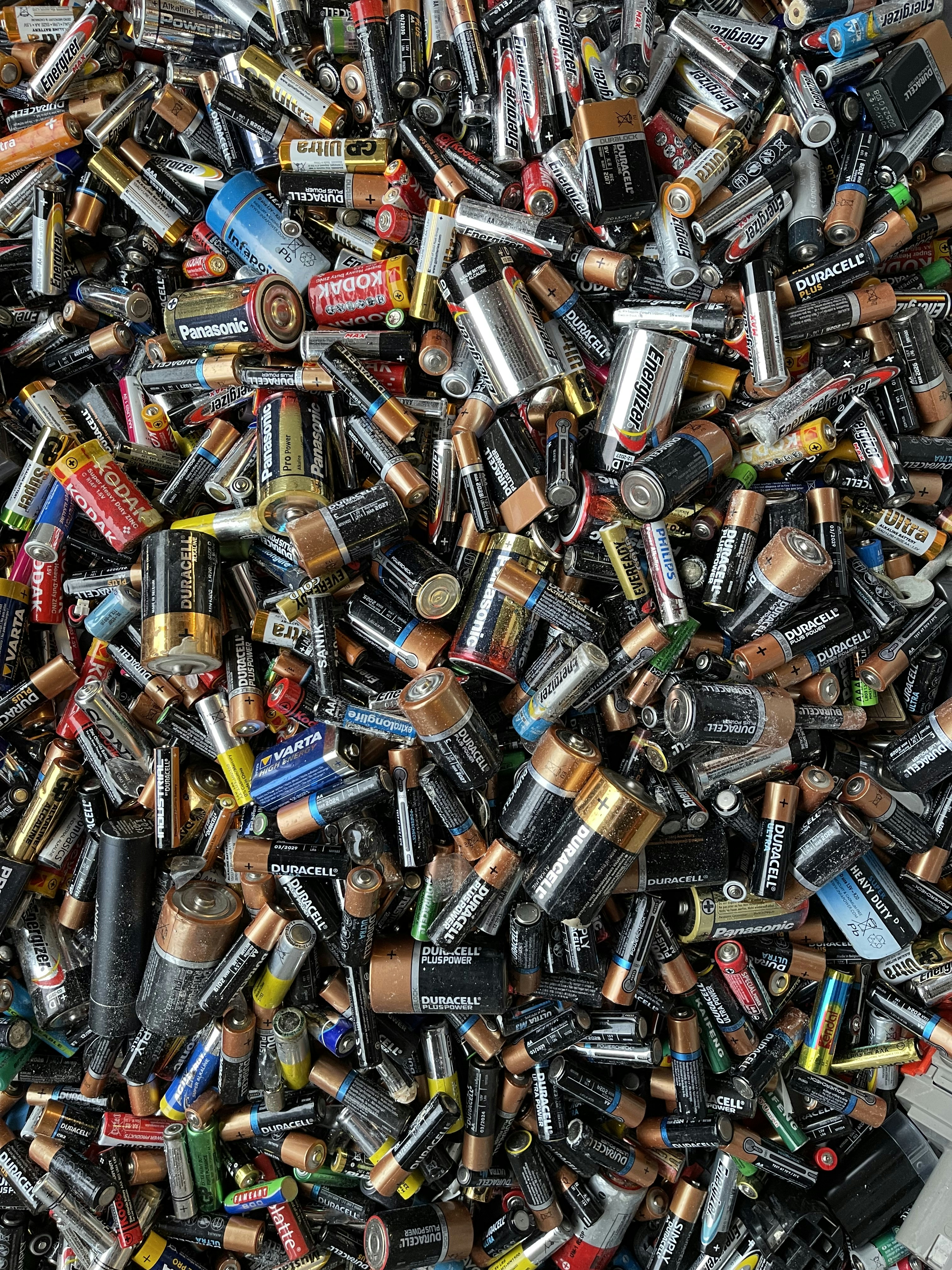 a pile of different types of batteries and batteries