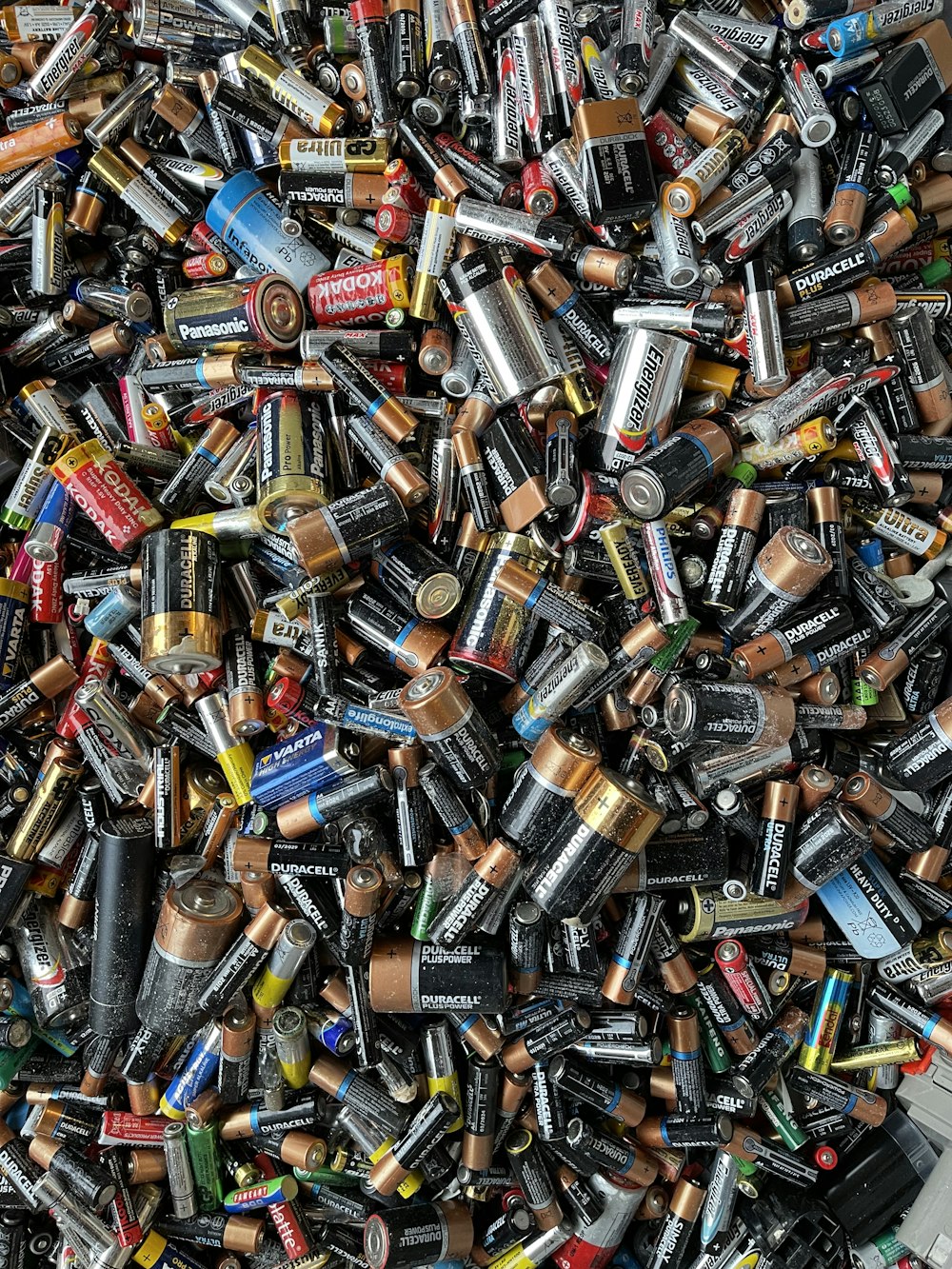 a pile of different types of batteries and batteries