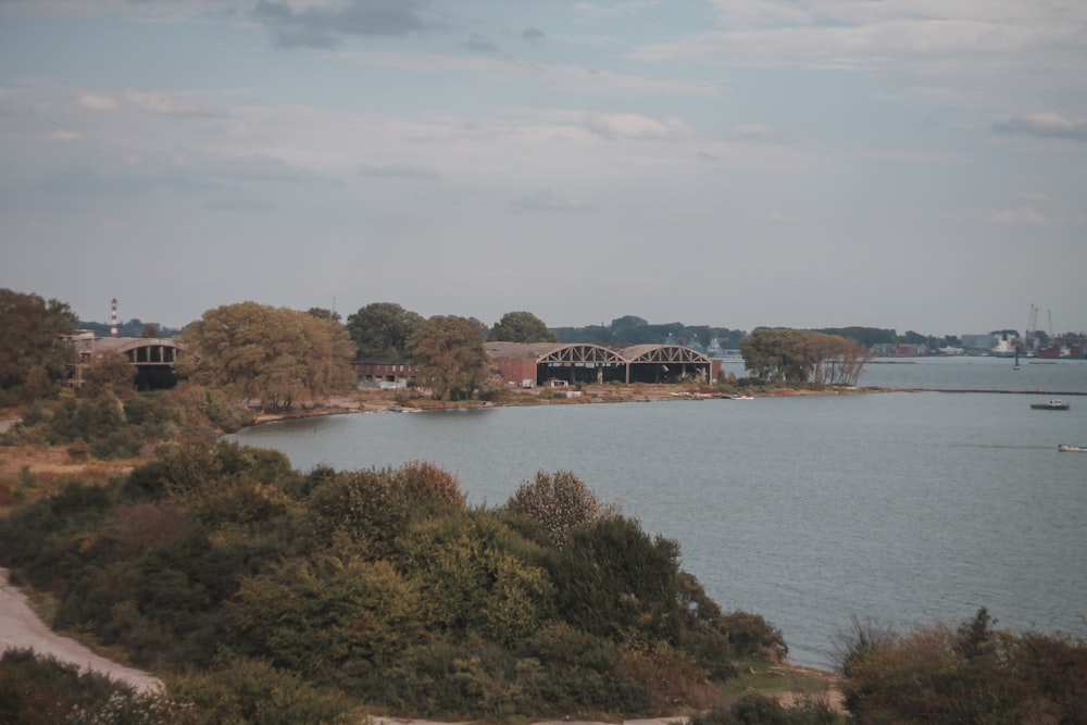 a body of water surrounded by trees and buildings