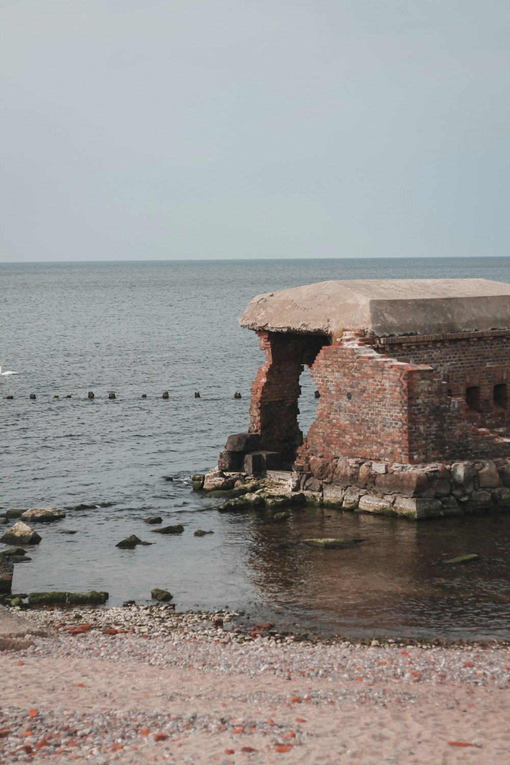 a large body of water next to a brick structure