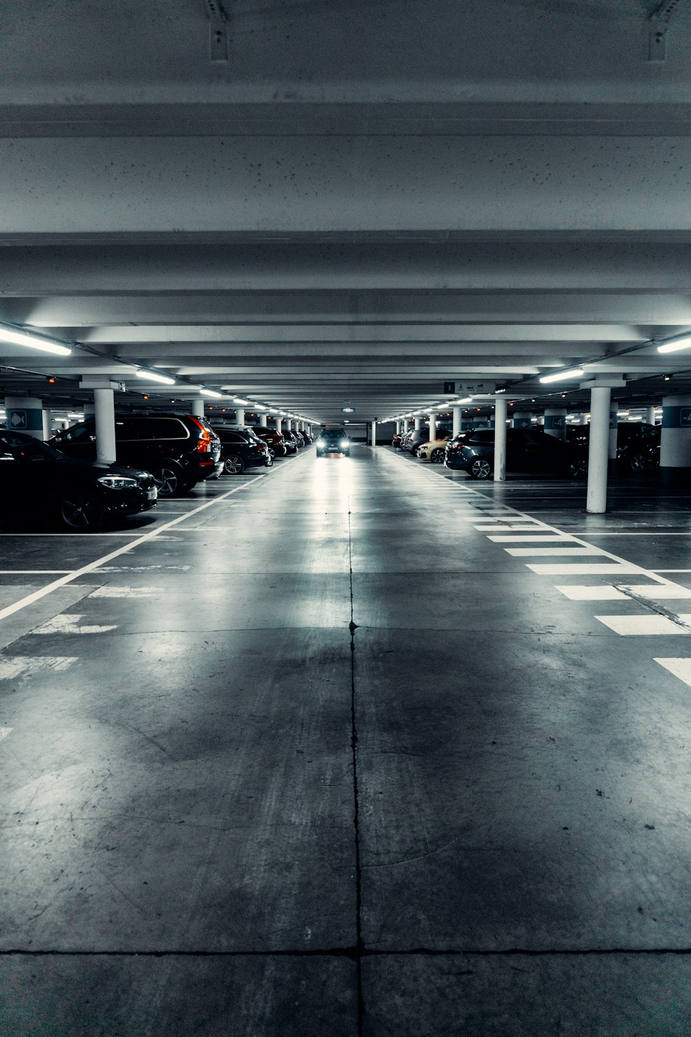a parking garage filled with lots of parked cars