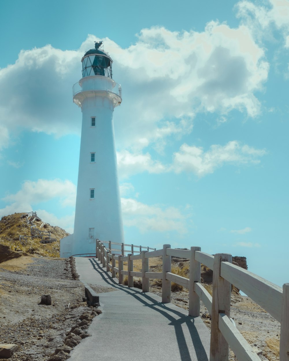 a white lighthouse with a light house on top of it