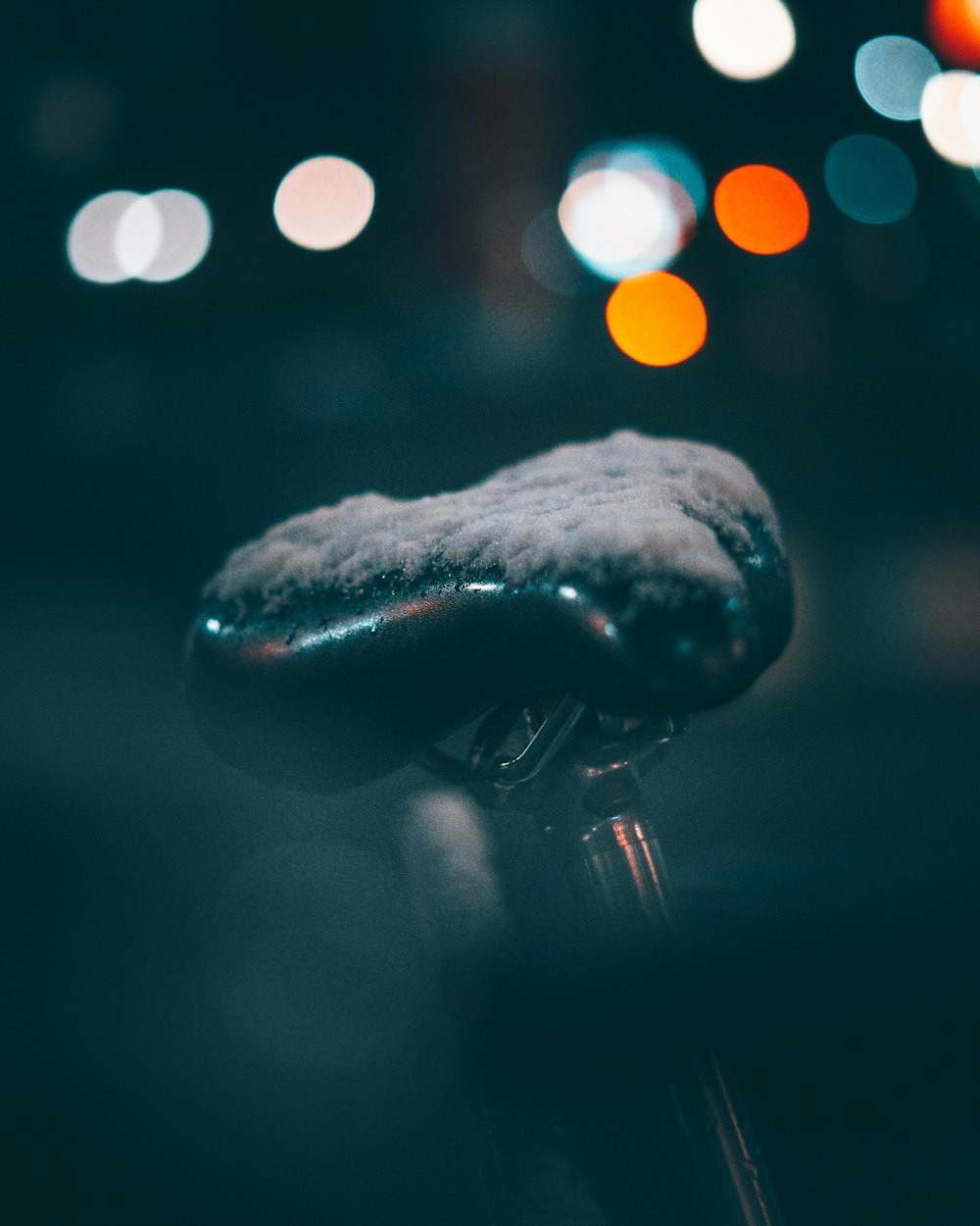 a close up of a bike handle with snow on it