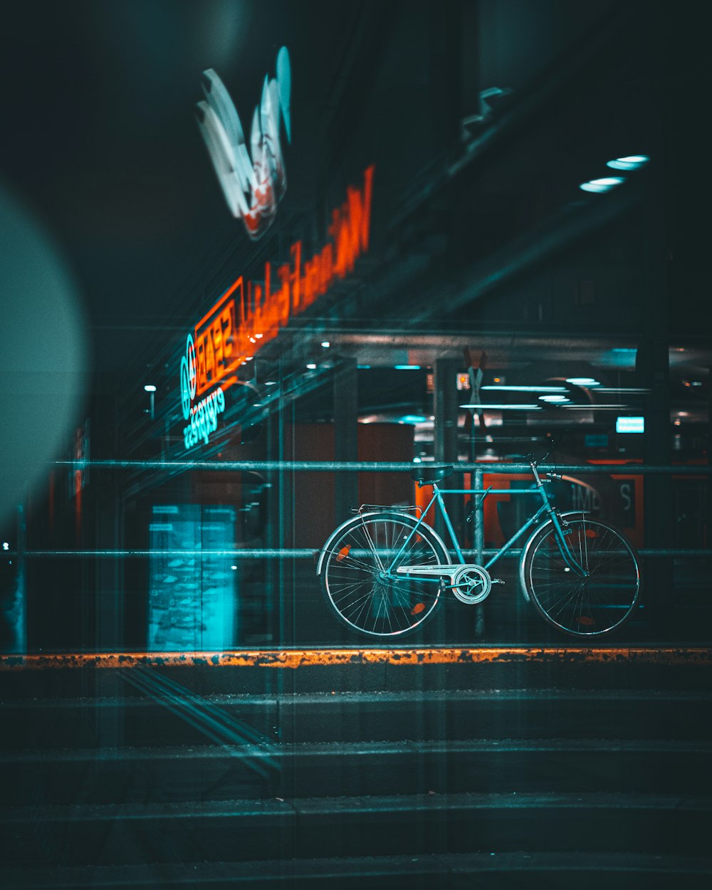 a bicycle parked in front of a neon sign