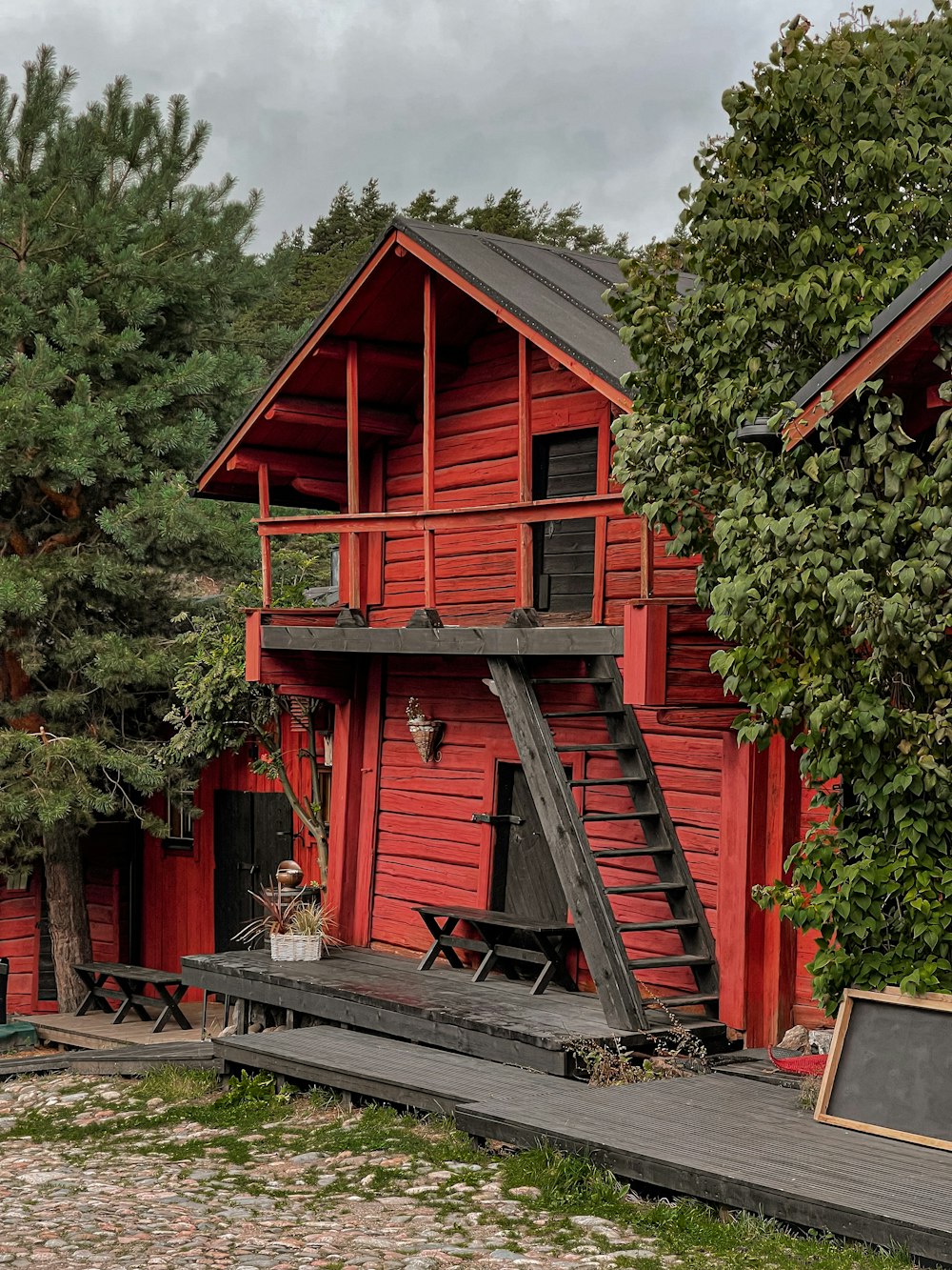 a red house with a wooden deck and stairs