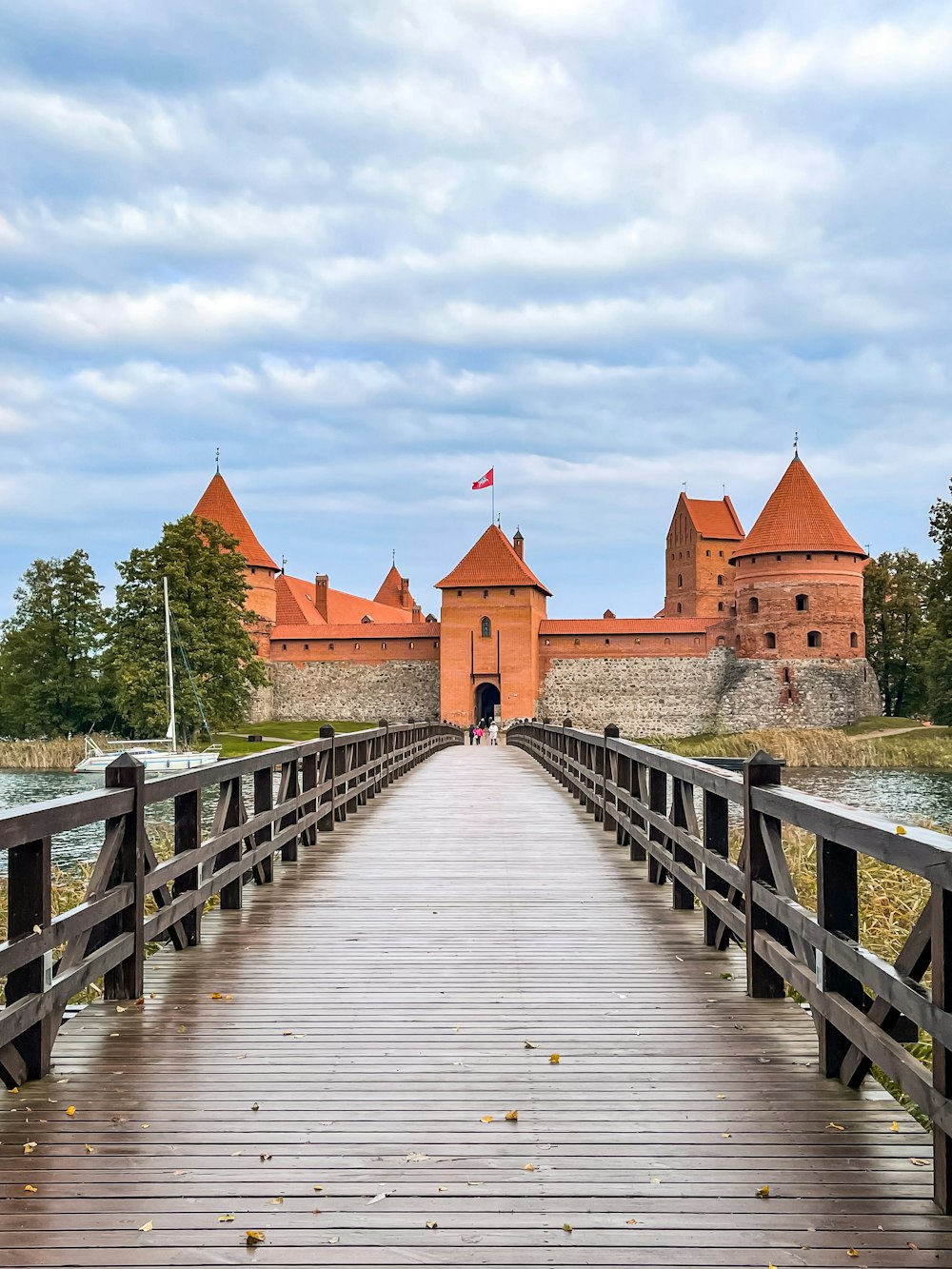 a wooden bridge with a castle in the background