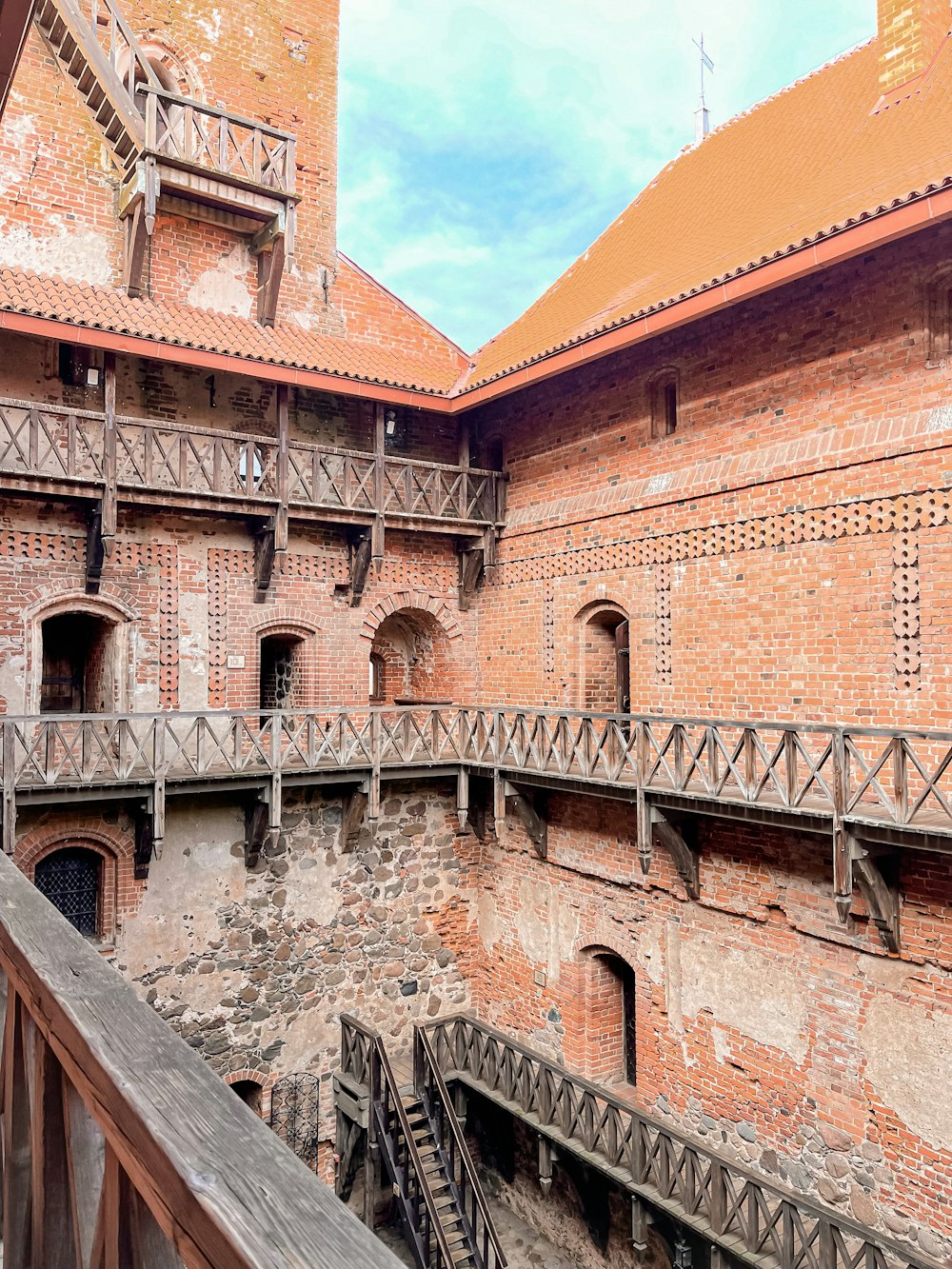 an old brick building with stairs leading up to it