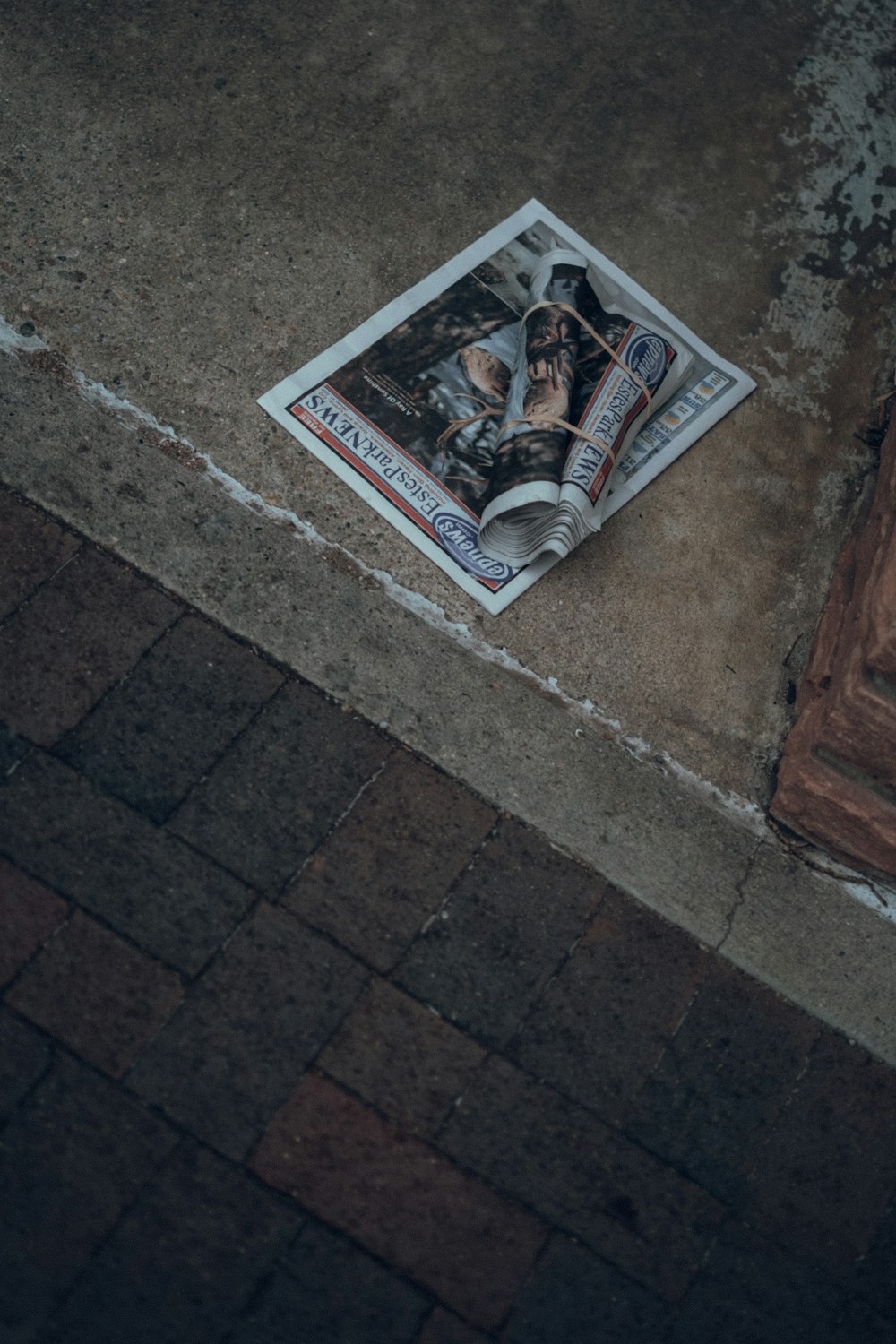 a newspaper laying on the ground next to a door