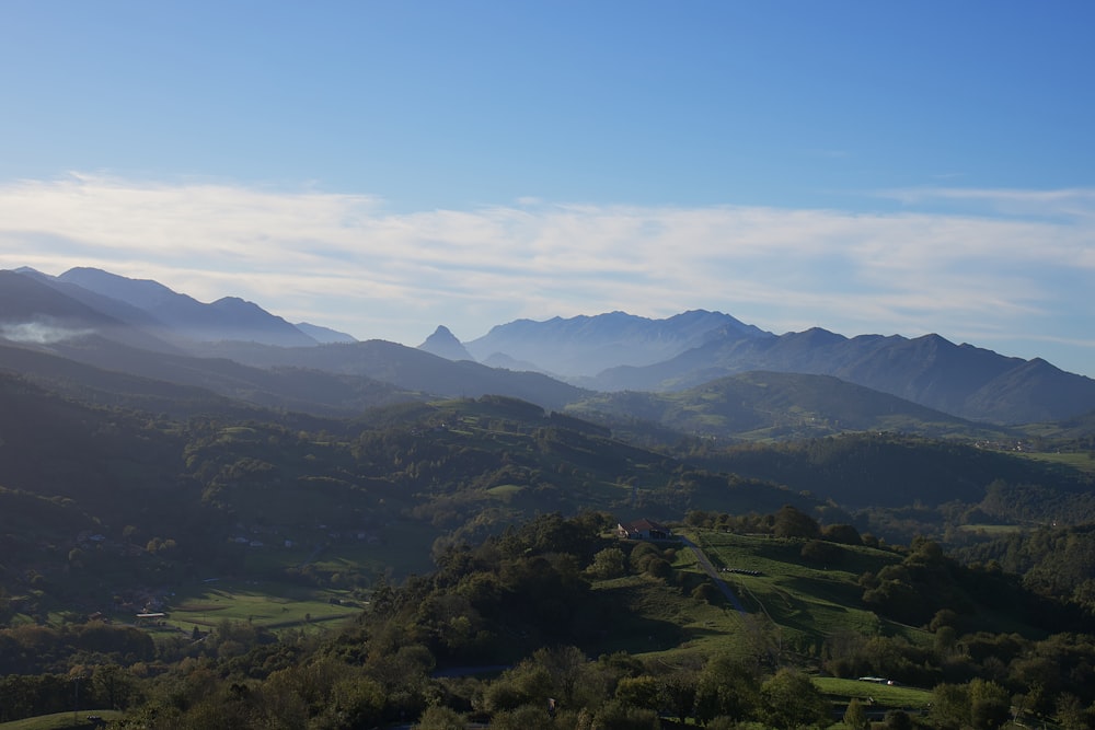 a view of a valley with mountains in the background