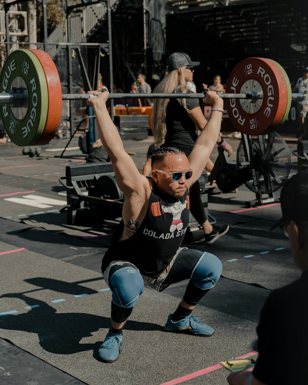 a man squatting with a barbell in his hands
