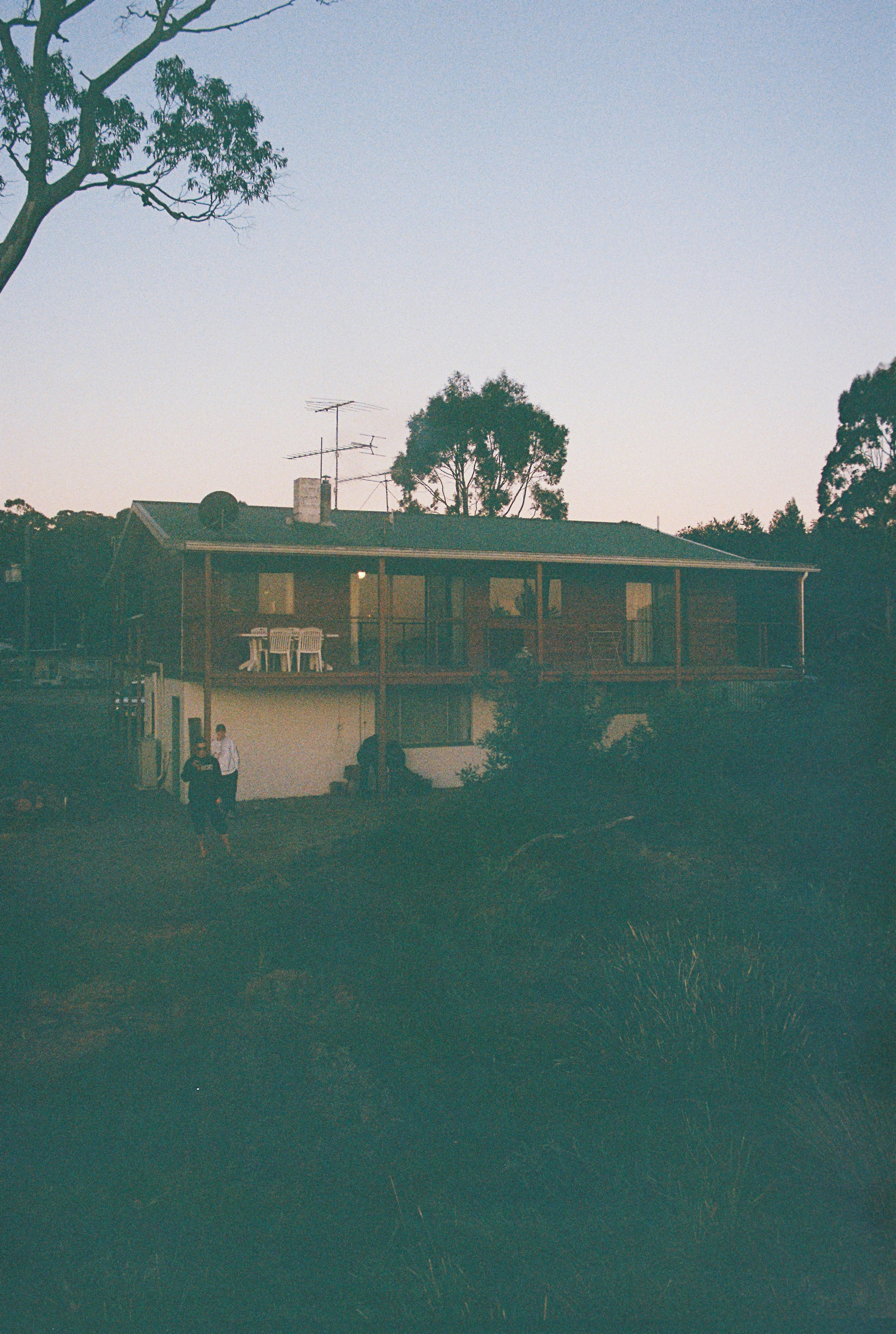 a couple of people standing in front of a house
