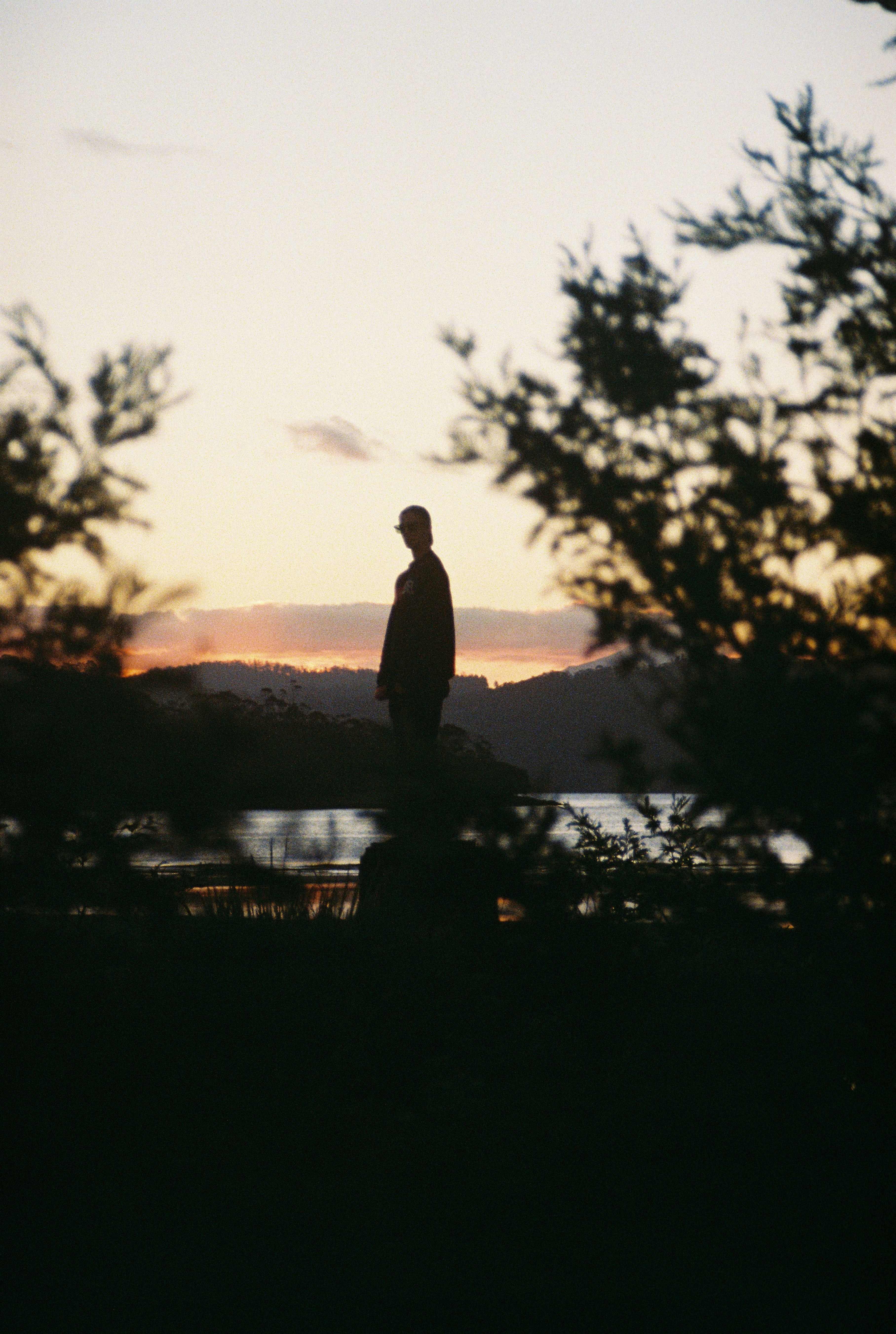 a man standing on top of a lush green field