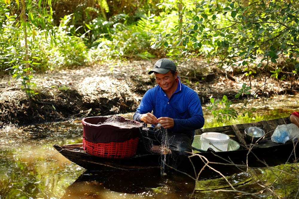 a man sitting in a boat in a river