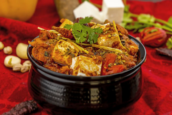 a bowl of food on a red table cloth