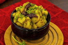 a bowl of food sitting on top of a wooden plate