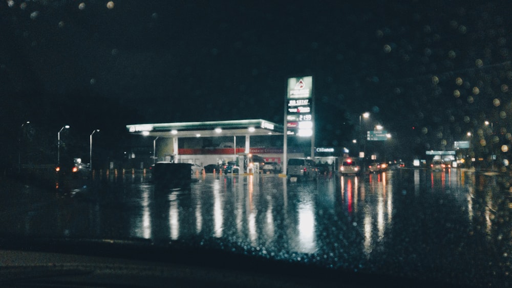 a city street at night with rain on the ground