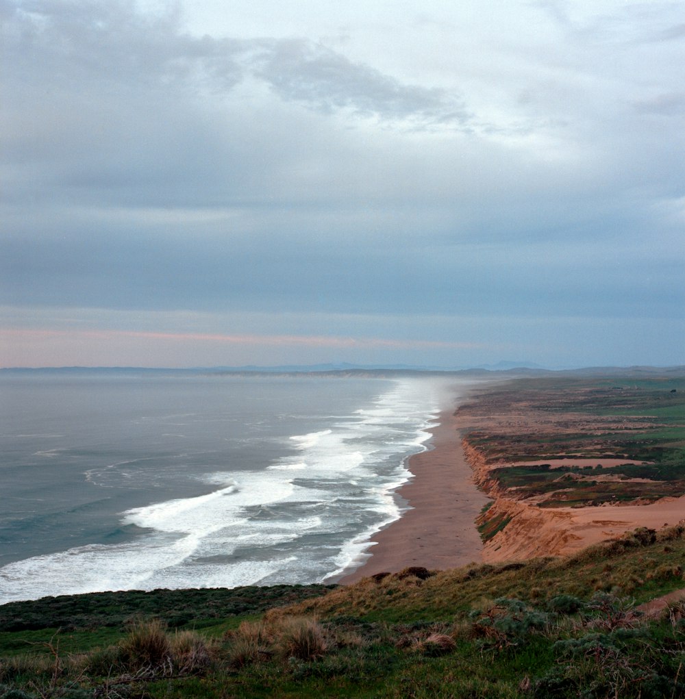 a view of the ocean from the top of a hill