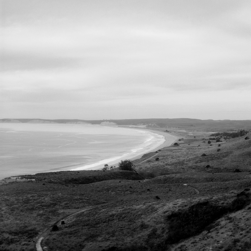 a black and white photo of a beach