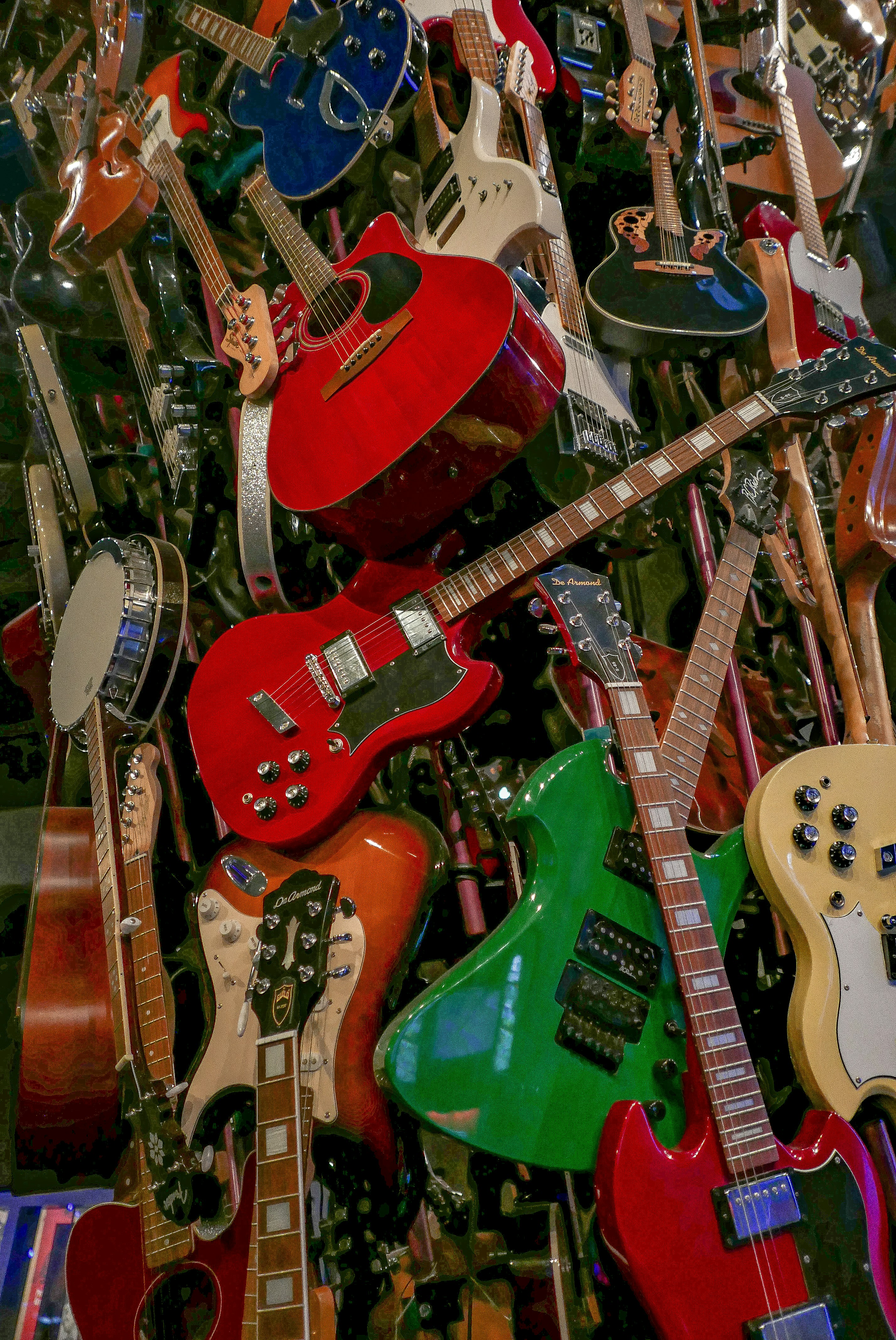 a pile of guitars sitting next to each other