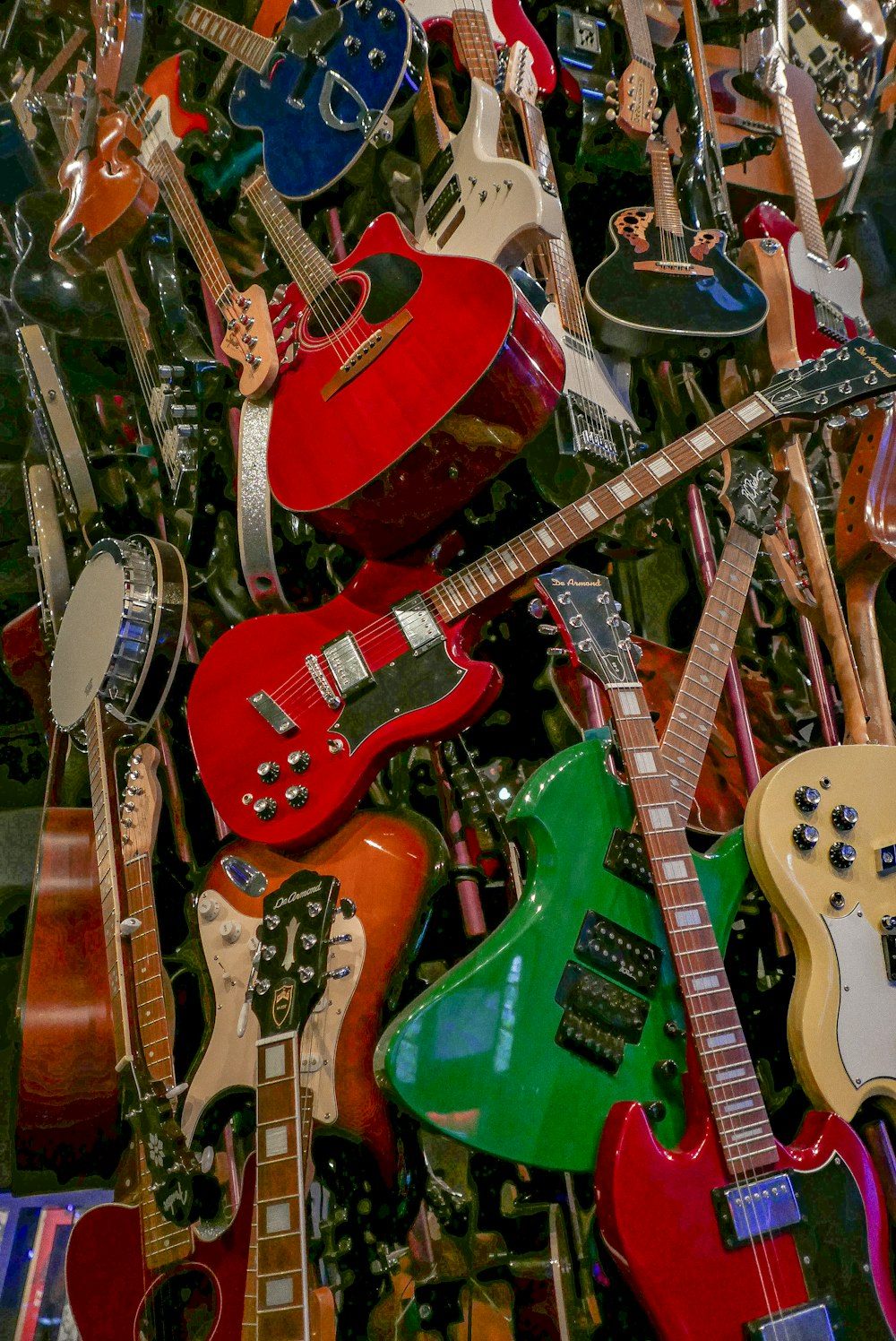 a pile of guitars sitting next to each other