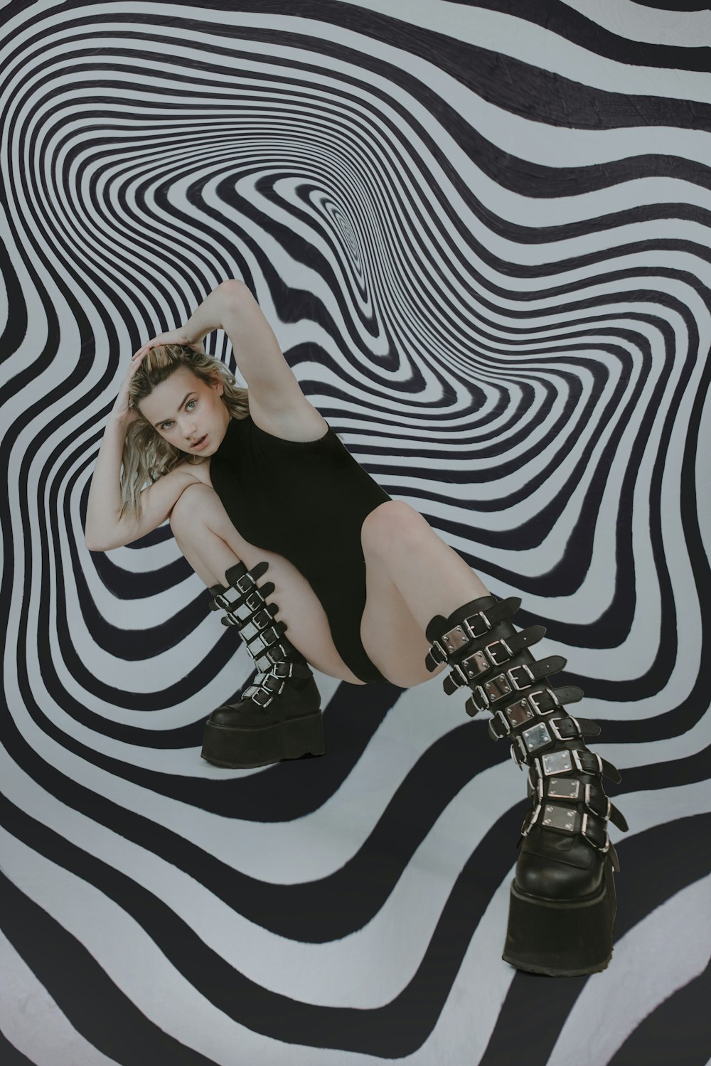 a woman sitting on top of a zebra print floor