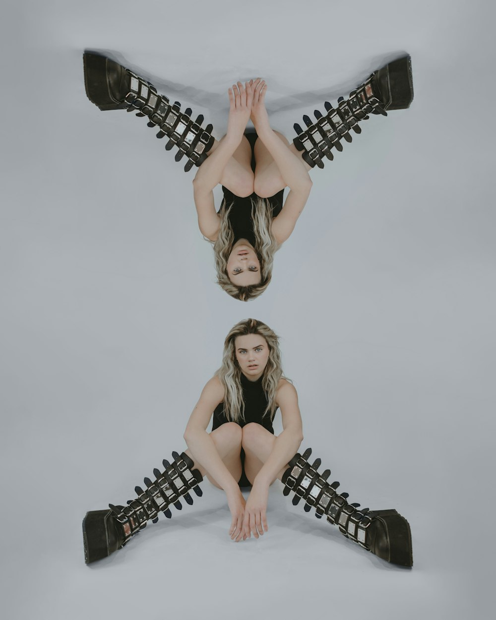 a woman sitting on the ground with her legs crossed