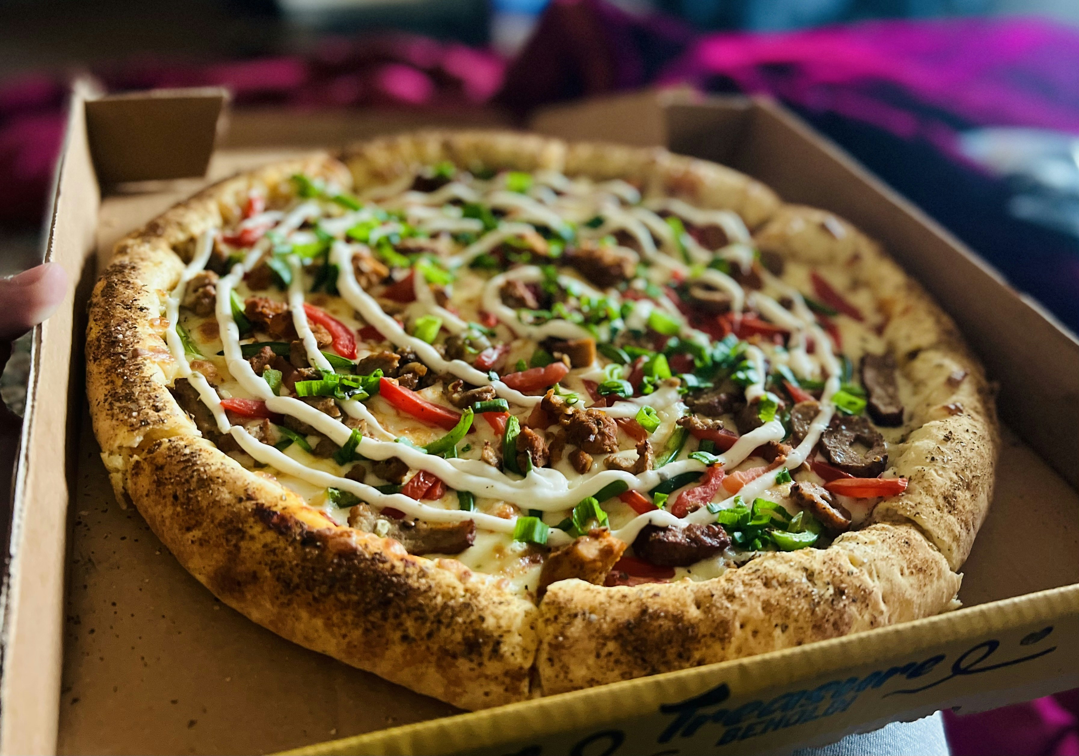 a pizza sitting in a box on a table
