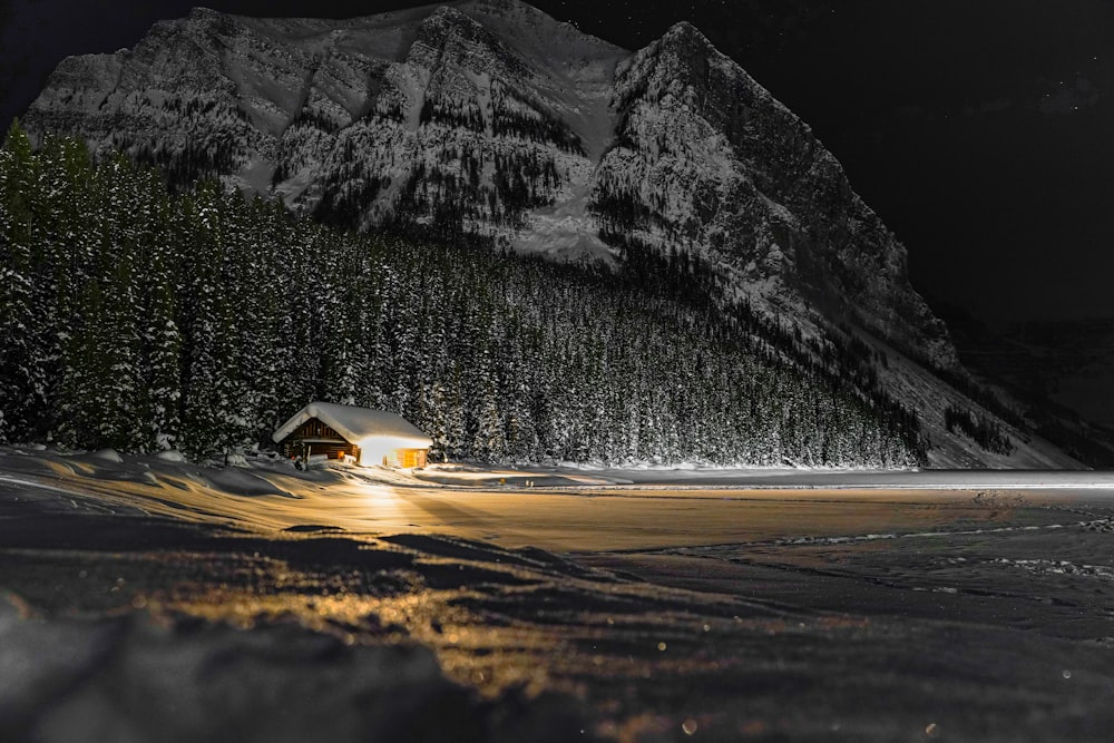 a cabin in the middle of a snowy mountain