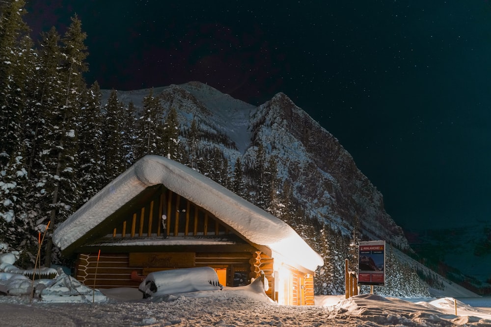 a cabin in the middle of a snowy mountain