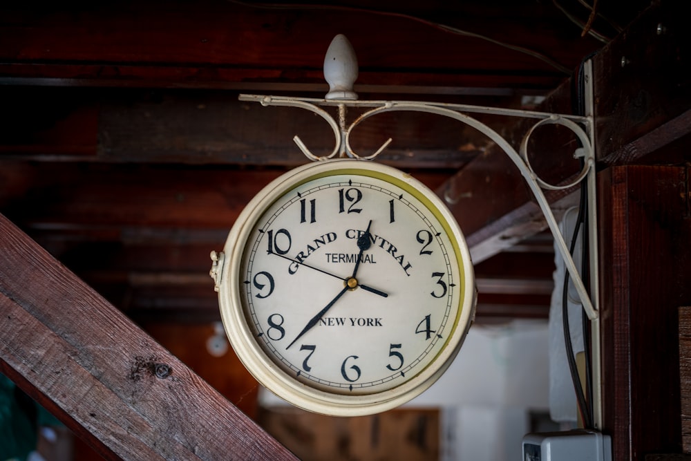 a clock hanging from the ceiling of a room