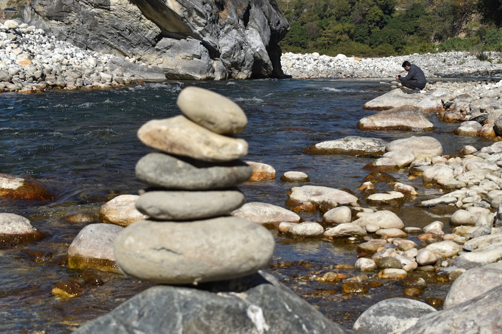 a pile of rocks sitting on top of a river