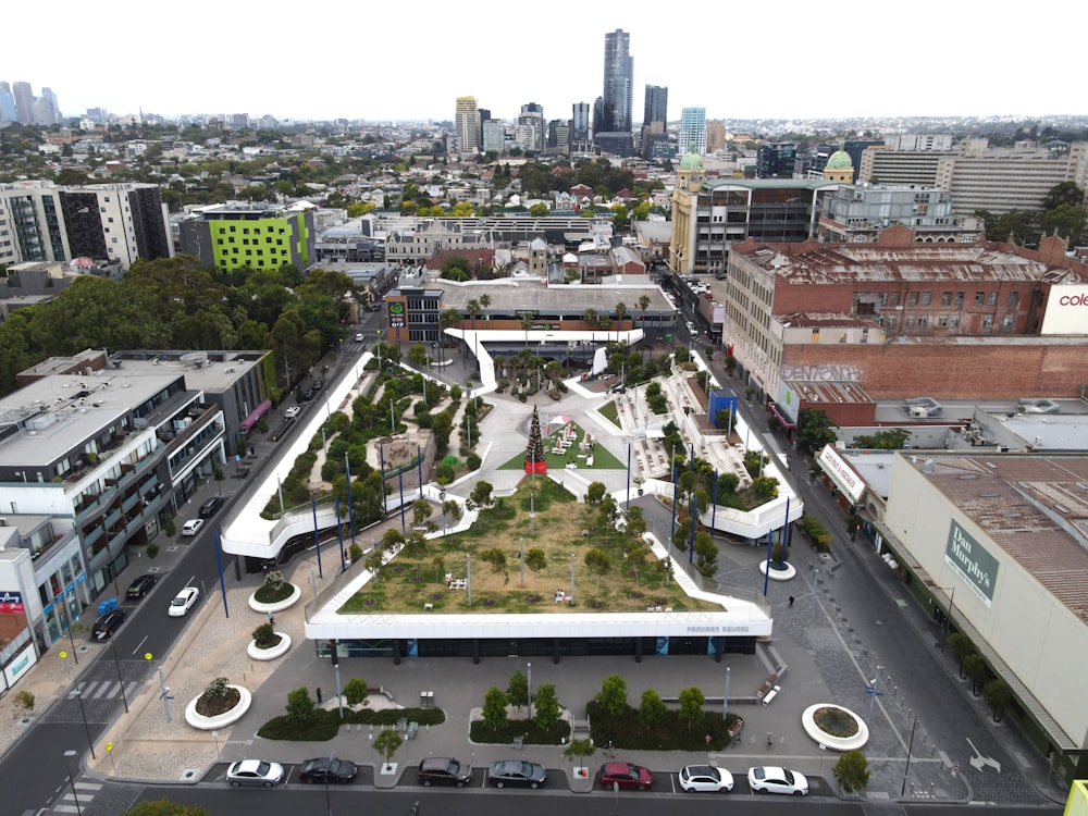 an aerial view of a city with a green roof