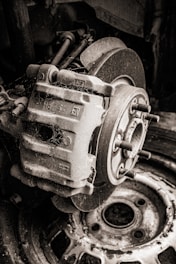 Close-up of used brake pads and discs stacked on a shelf.