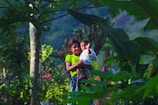 a couple of kids that are standing in the grass
