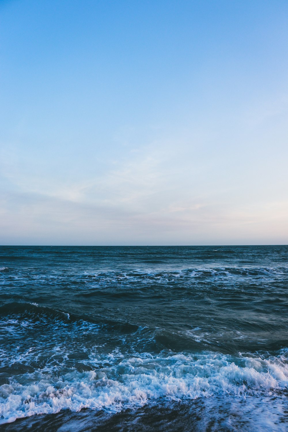 a view of a body of water with waves