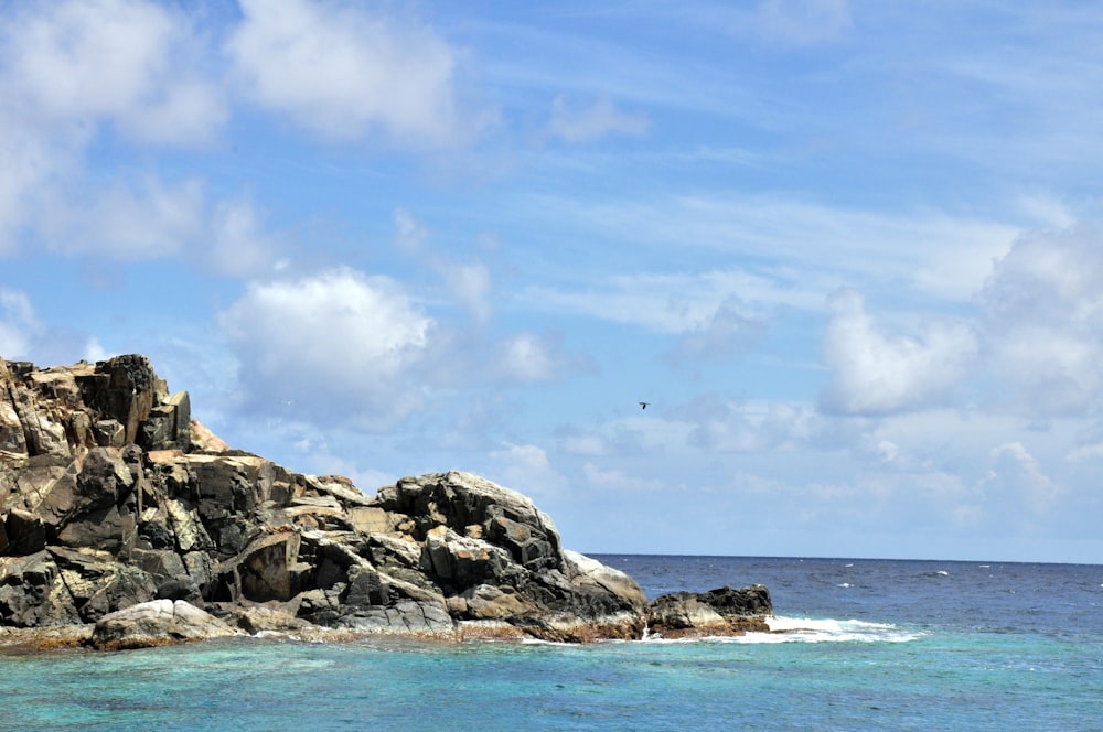 a rocky outcropping in the middle of the ocean