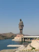 a large statue of a man standing on top of a bridge