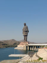 a large statue of a man standing on top of a bridge