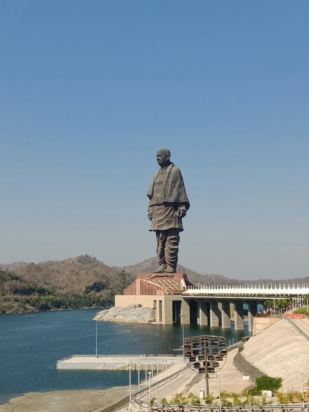 a large statue of a man standing on top of a bridge
