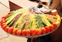 a large platter of various vegetables and grains