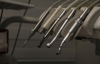 a row of dental instruments hanging from a wall