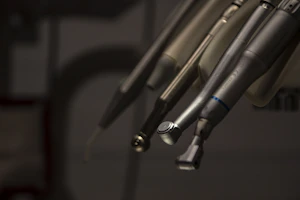 a close up of a pair of scissors hanging from a hook