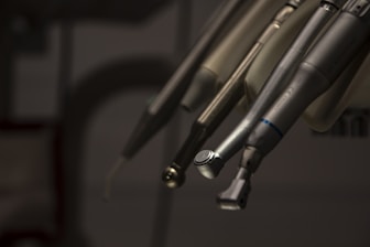 a close up of a pair of scissors hanging from a hook