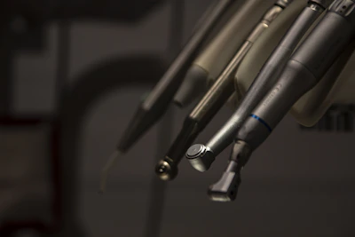 a close up of a pair of scissors hanging from a hook