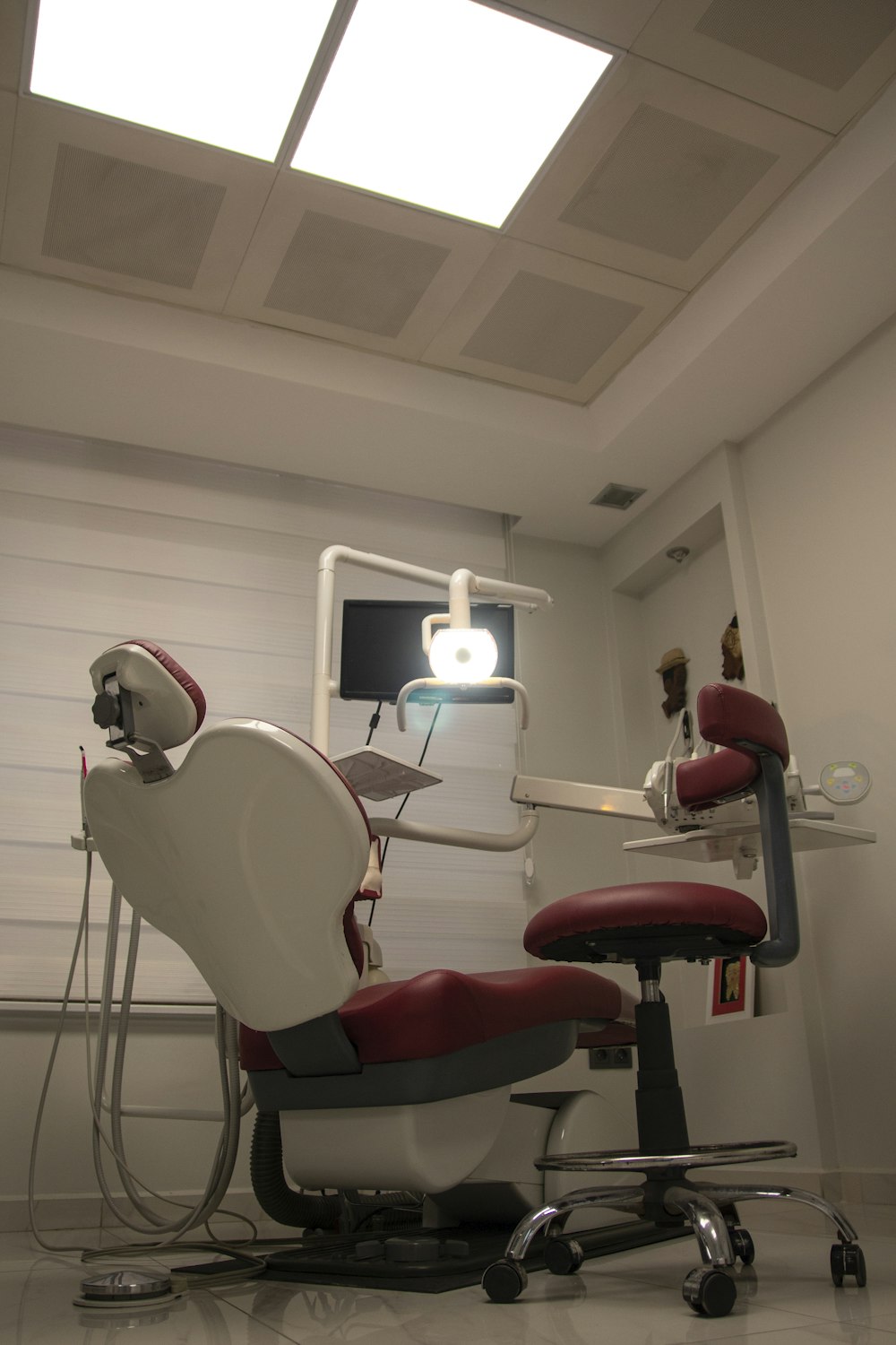 a dental room with a chair and a monitor