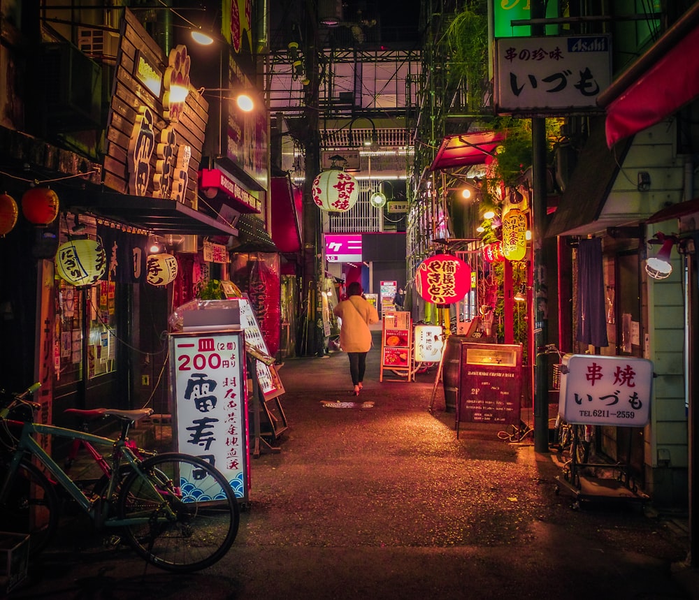 a person walking down a street at night